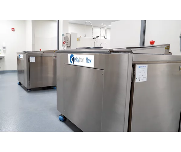 Two Skytron Flex Ultrasonic Washer Disinfectors side by side angled to the left in medical setting